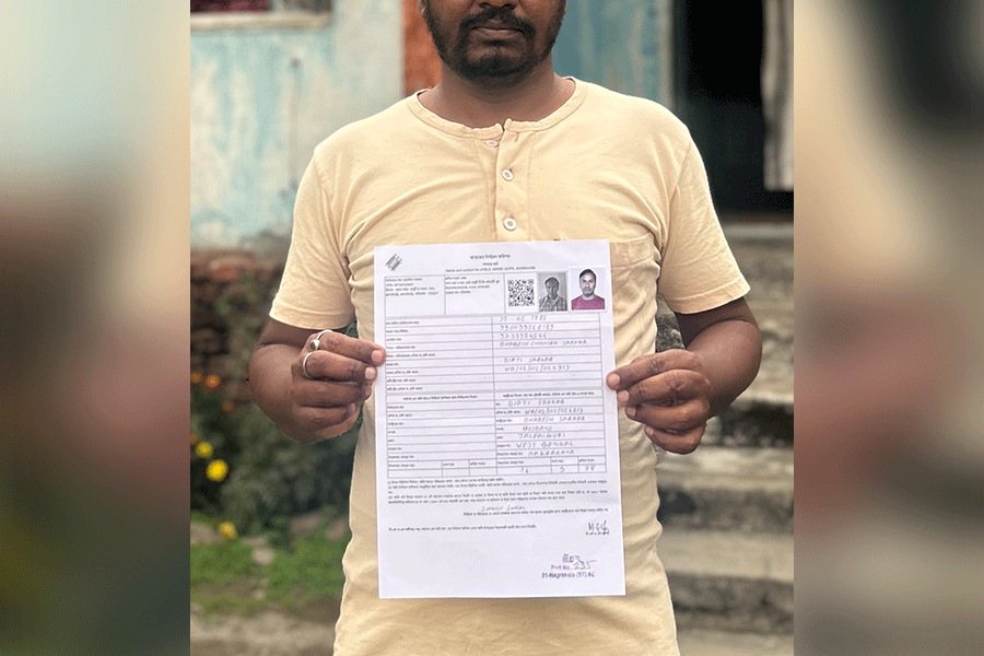 Surojit Sarkar holding his SIR form.