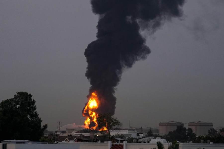 Fire and plumes of smoke rises after a drone struck a fuel tank forcing the temporary suspension of flights. near Dubai International Airport, in United Arab Emirates, early Monday, March 16, 2026.