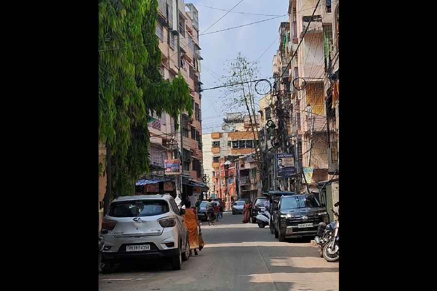 Cars parked on both sides of the road in Block B of Bangur Avenue make it difficult for a third car to pass through.