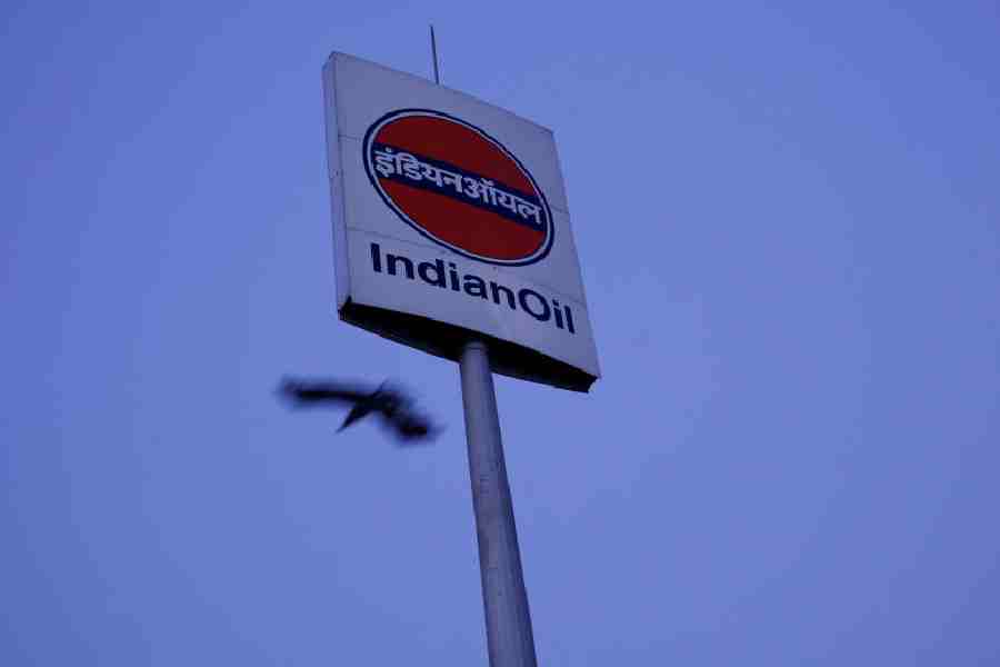 A bird flies next to a logo of Indian Oil outside a fuel station in New Delhi, India, March 4, 2025.