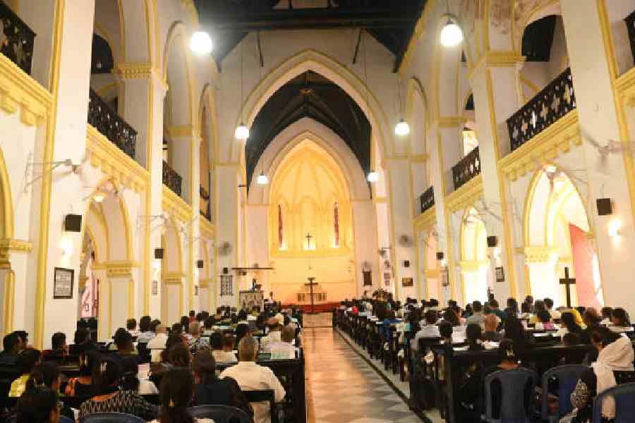 Prayers at St James’ Church; (below) the Church of Christ The King on Good Friday. Pictures by Bishwarup Dutta