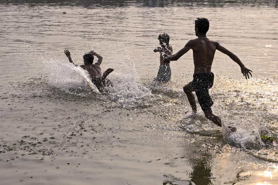 Young boys beat the heat by playing in a waterbody on a hot summer day, in Nadia district, West Bengal, Thursday, April 2, 2026.