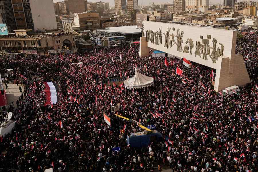 Followers of Iraq's Shiite cleric Muqtada al-Sadr chant slogans as they wave Iraqi flags during a protest against U.S. and Israeli attacks on Iran, in Tahrir Square, Baghdad, Iraq, Saturday, April 4, 2026.