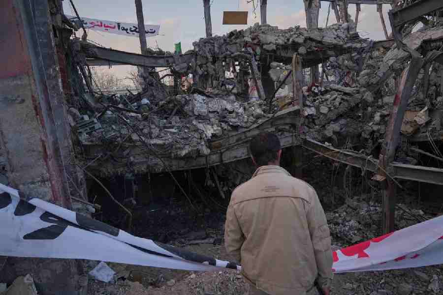 A man looks at a destroyed building within the Grand Hosseiniyeh complex that officials say was hit by U.S.-Israeli airstrikes Tuesday in Zanjan, Iran, Saturday, April 4, 2026.