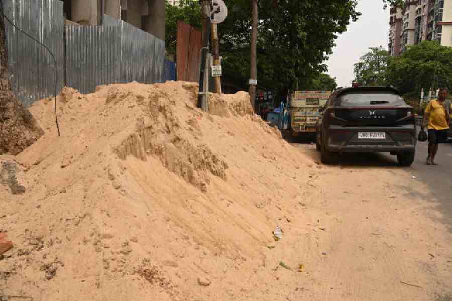 Heaps of sand along Prince Anwar Shah Road on Sunday