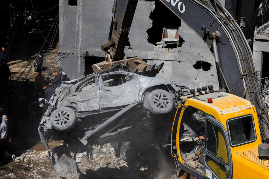Heavy machinery is used to move a damaged car at the site of Sunday's Israeli strike on a building, amid escalating hostilities between Israel and Hezbollah, as the U.S.-Israel conflict with Iran continues, in the Jnah area in Beirut, Lebanon, April 6, 2026.