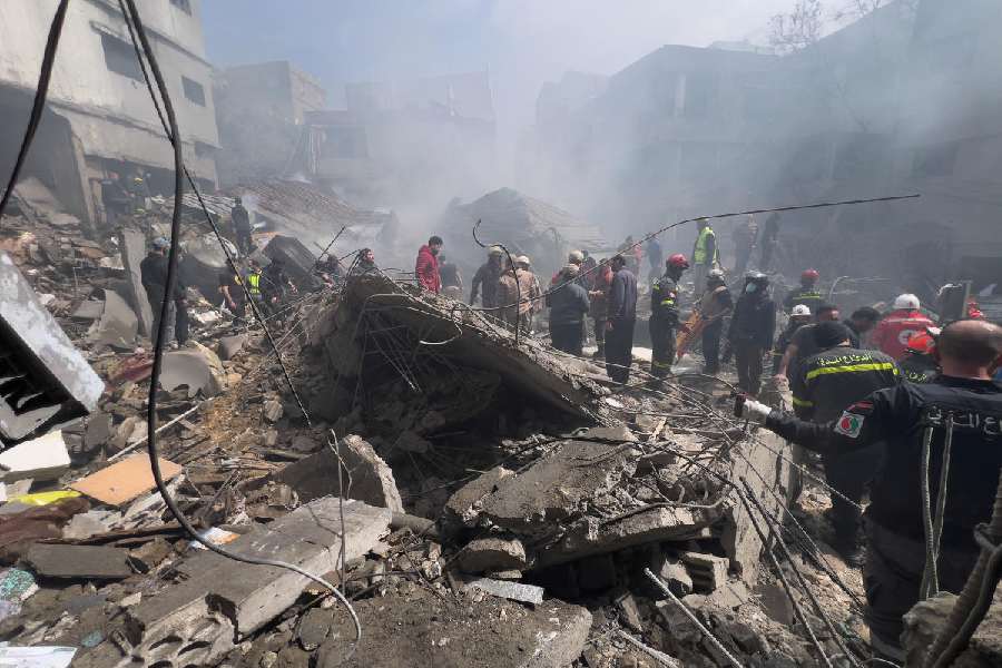 Rescue workers search for victims at the site of an Israeli airstrike that hit a crowded neighbourhood south of Beirut, Lebanon, Sunday, April 5, 2026.