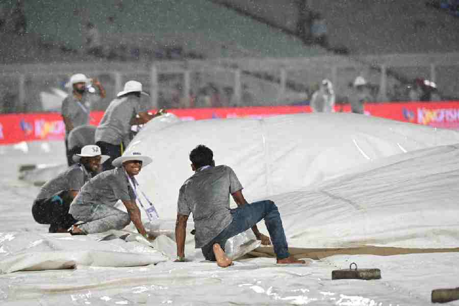 Groundstaff hold on to the covers at Eden Gardens as heavy rain and strong winds lash the venue, stopping play during Kolkata Knight Riders’ match against Punjab Kings on Monday.