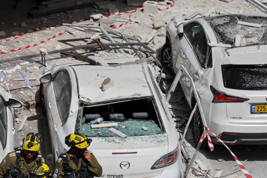 Emergency personnel work at impact site, following barrage of missiles launched from Iran, in central Israel