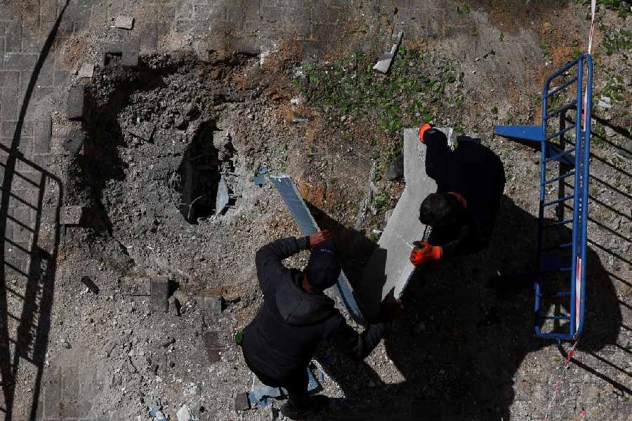 Emergency responders work at an impact site after a barrage of missiles was launched from Iran into Israel, amid the U.S.-Israel conflict with Iran, in central Israel, April 7, 2026.
