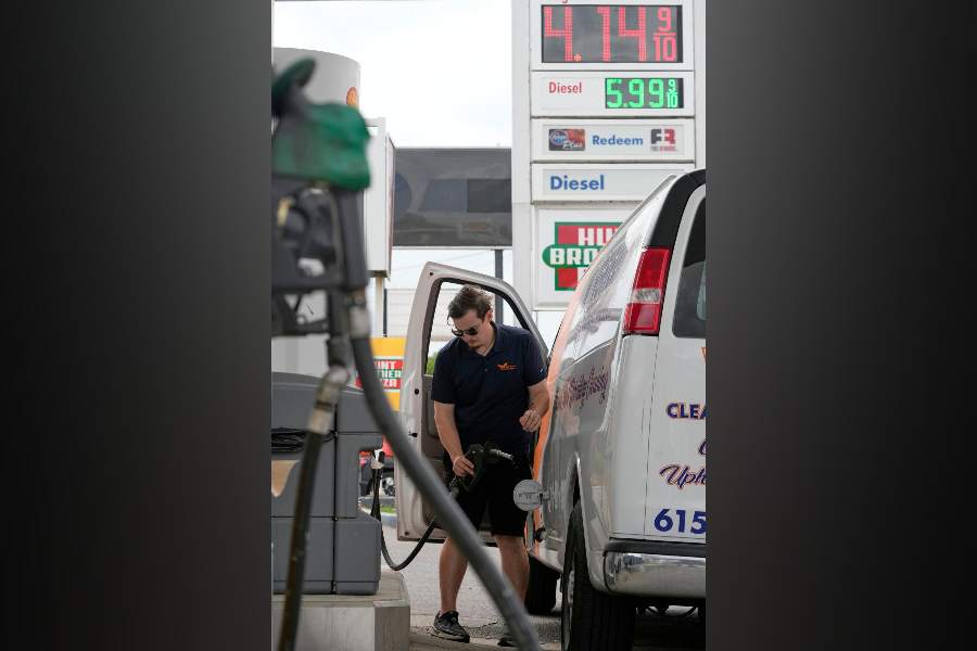 Patrick McGoldrick fills his van with fuel at a gas station, Monday, March 30, 2026, in Nashville, Tenn. as the price per gallon is displayed above.