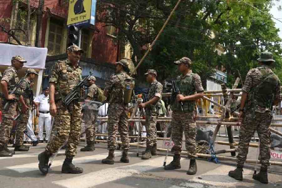 Central force personnel and policemen outside the Survey Building in Alipore on Tuesday. (Sanat Kr Sinha)