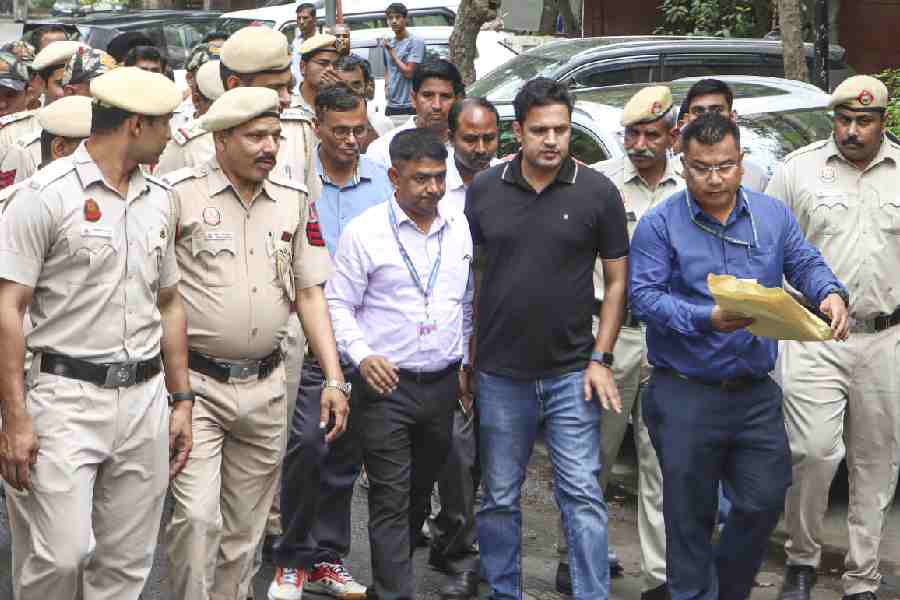 An Assam police team leaves Pawan Khera’s home in New Delhi on Tuesday.