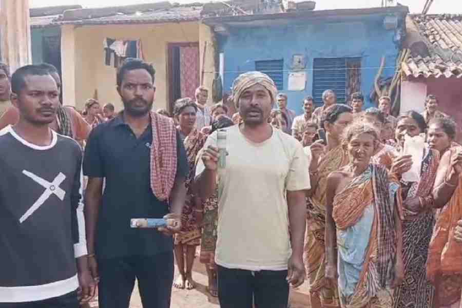 Kantamala villagers hold up remnants of tear gas shells fired at them during the police raid on Tuesday