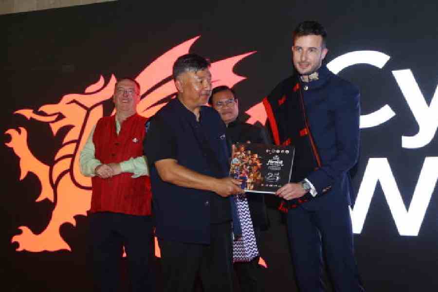 Eoghan O'Regan, head of India, Welsh government, receives a Hornbill festival souvenir from a representative of the government of Nagaland 