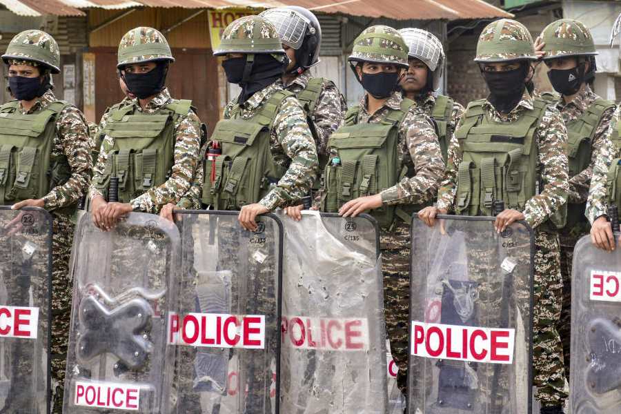 Police personnel stand guard after a protest broke out under the banner of Coordinating Committee on Manipur Integrity (COCOMI), following a bomb attack in Bishnupur on Tuesday, leaving two children dead, in Wangkhei area of Imphal, Manipur, Wednesday, April 8, 2026.