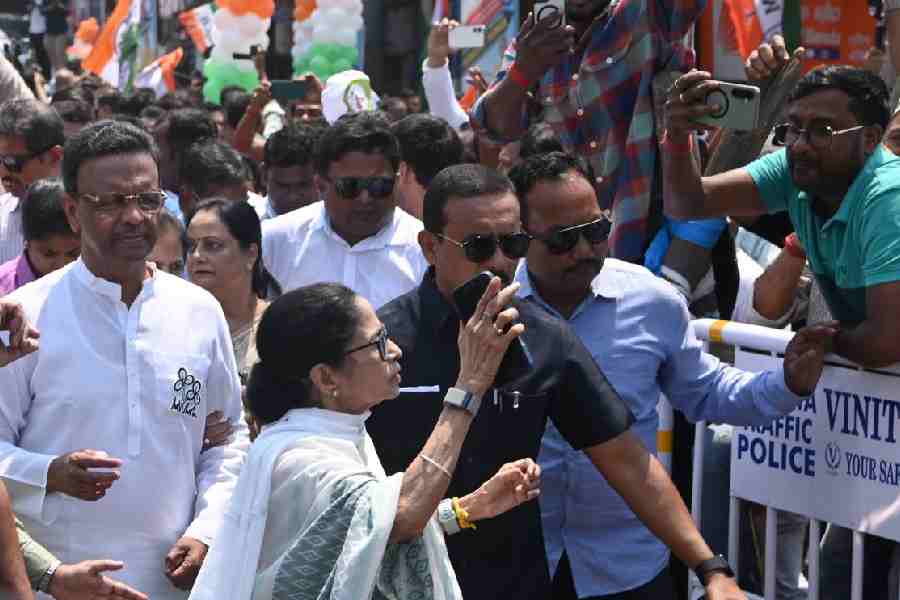 Mamata Banerjee greets supporters on her way to file her nomination on Wednesday.