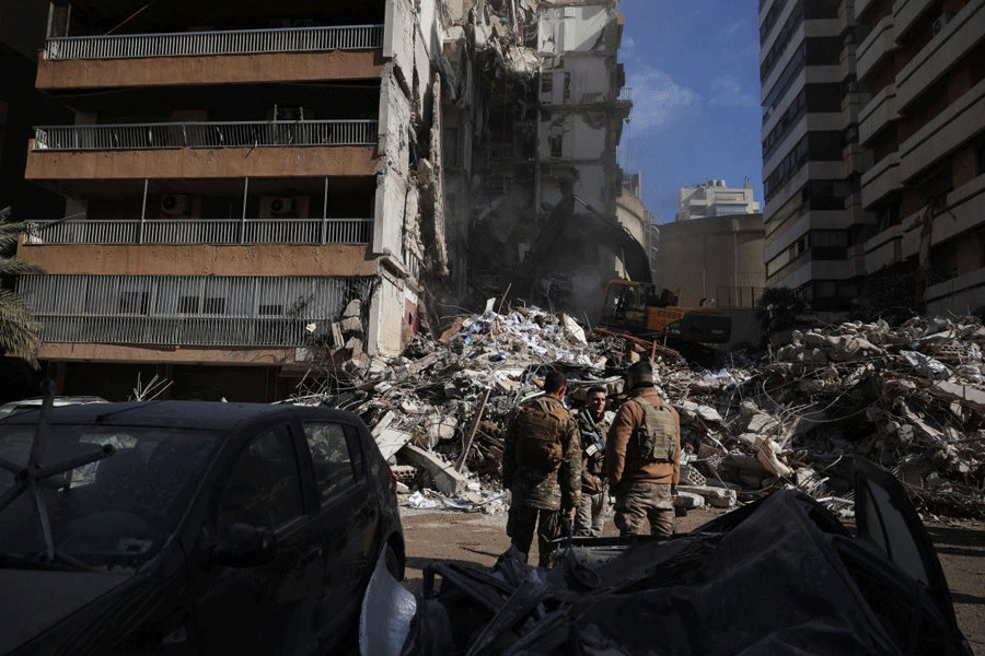Soldiers stand at the site of an Israeli strike carried out on Wednesday, in Tallet El Khayat in Beirut, Lebanon, April 9, 2026.