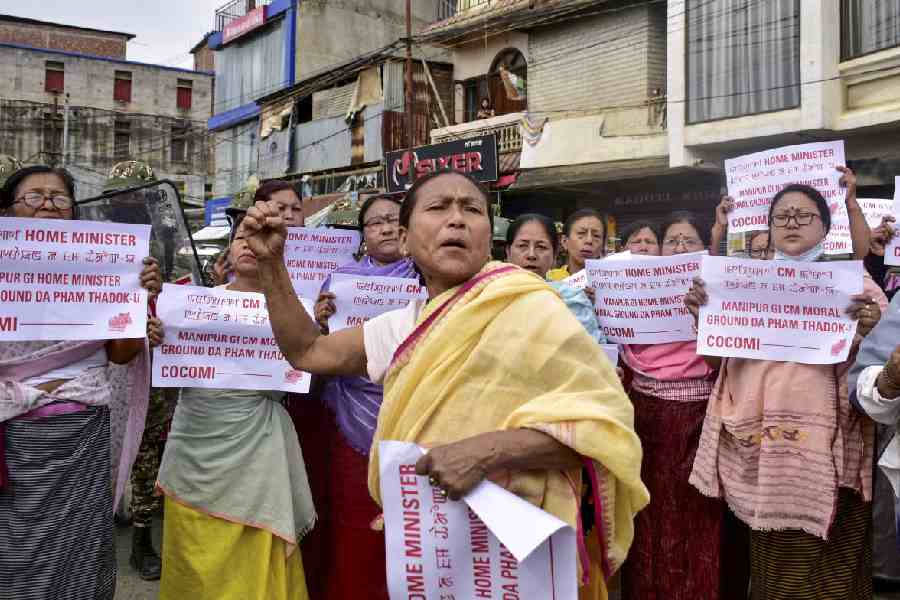 Women hold up posters