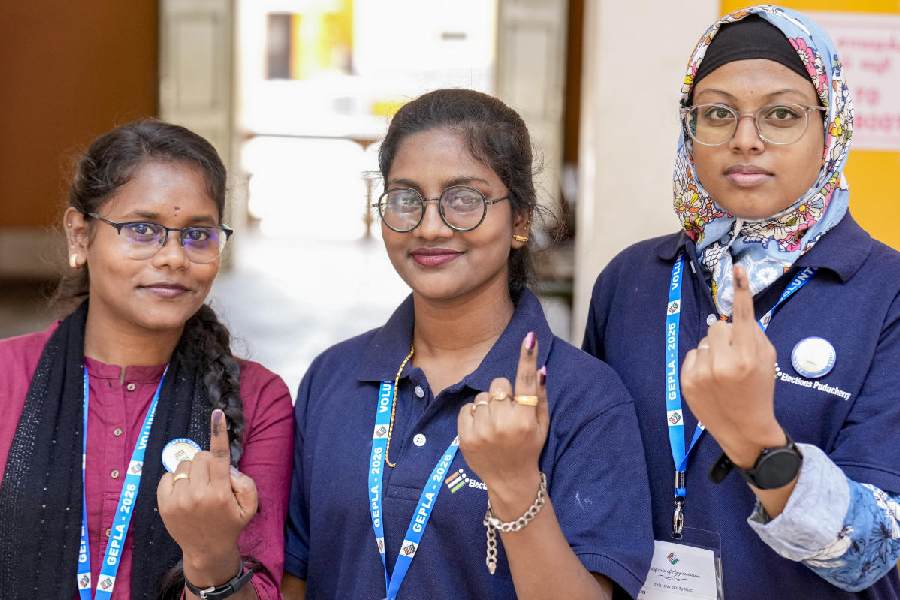 People show their ink-marked fingers after casting votes during the Puducherry Assembly elections, at a polling station in Puducherry, Thursday, April 9, 2026.