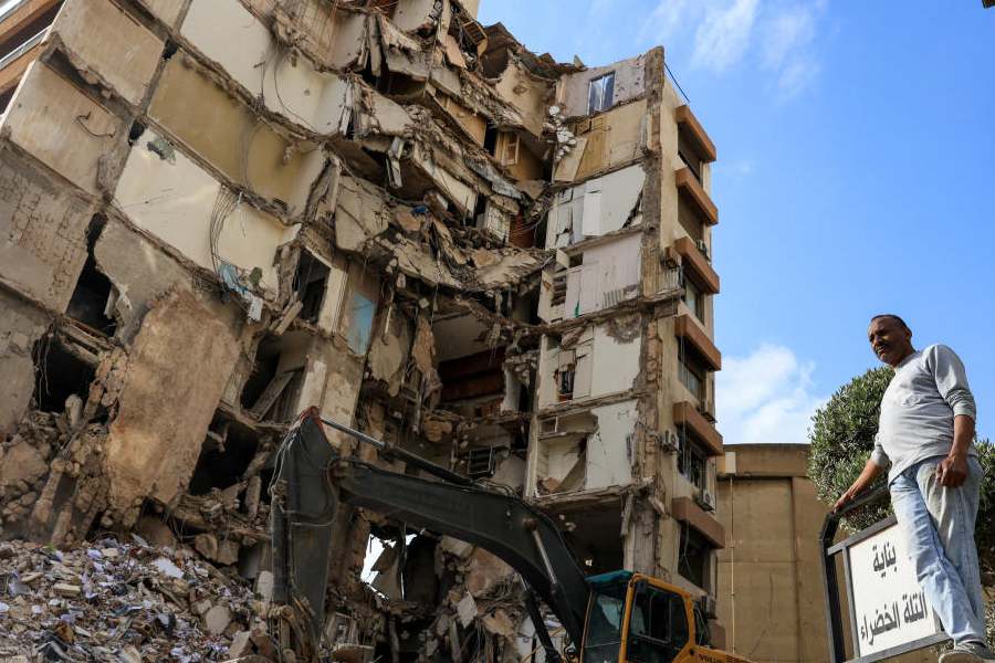 A man stands near a damaged building at the site of an Israeli strike carried out on Wednesday, in Tallet El Khayat in Beirut, Lebanon, April 9, 2026.