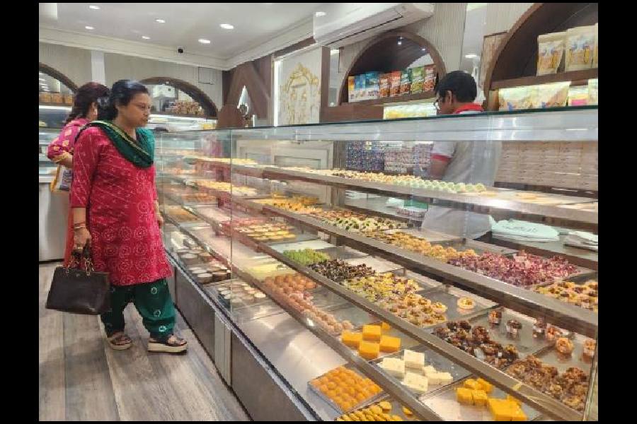Customers browse the delicacies at Nepal Sweets, next to City Centre
