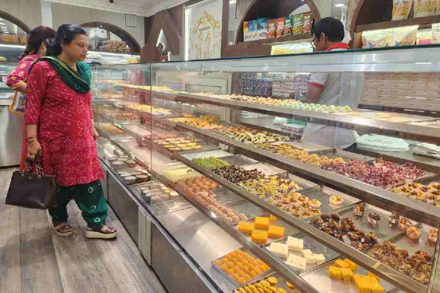 Customers browse the delicacies at Nepal Sweets, next to City Centre