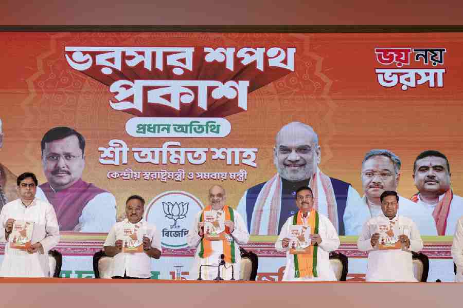 Union Home Minister Amit Shah, centre, Union Minister Sukanta Majumdar, right, Leader of Opposition in the West Bengal Assembly Suvendu Adhikari, second right, state BJP President Samik Bhattacharya, second left, and others during the unveiling of 'BJP Sankalp Patra', the party's manifesto for the upcoming state Assembly elections, in Kolkata, Friday, April 10, 2026.