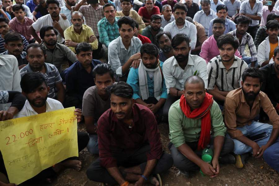 Factory workers hold a protest demanding wage hikes from their company, in Manesar, Haryana, India, April 7, 2026.