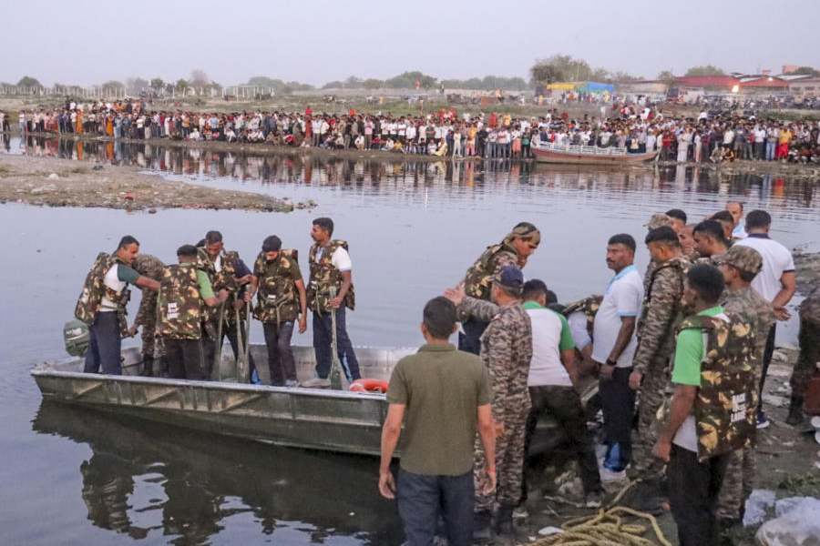 Rescue personnel during a search operation in the Yamuna River after a boat carrying pilgrims capsized near Kesi Ghat, in Mathura district, Friday, April 10, 2026. At least six people were allegedly killed and several others remain missing.