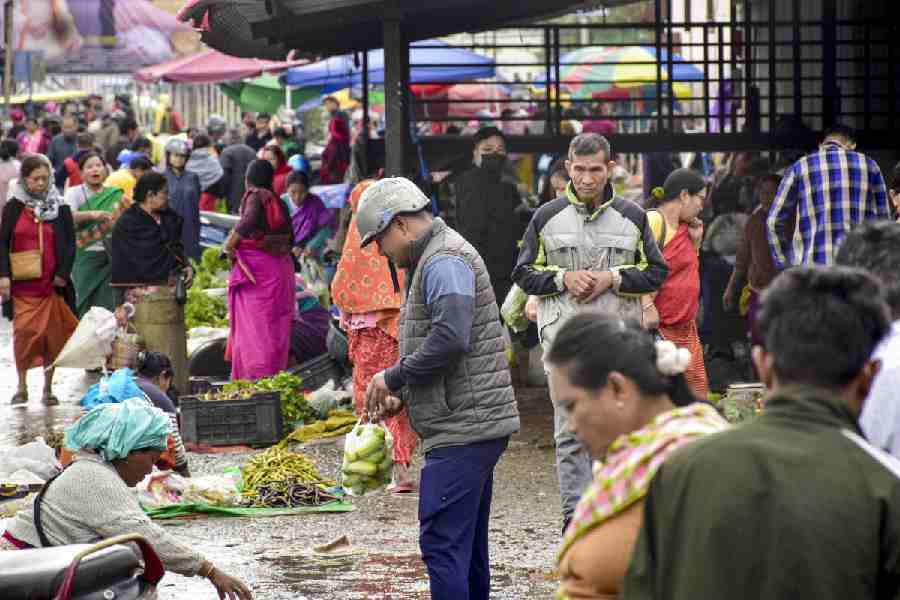 People buy essentials at a market after curfew restrictions were temporarily relaxed in Imphal on Friday.