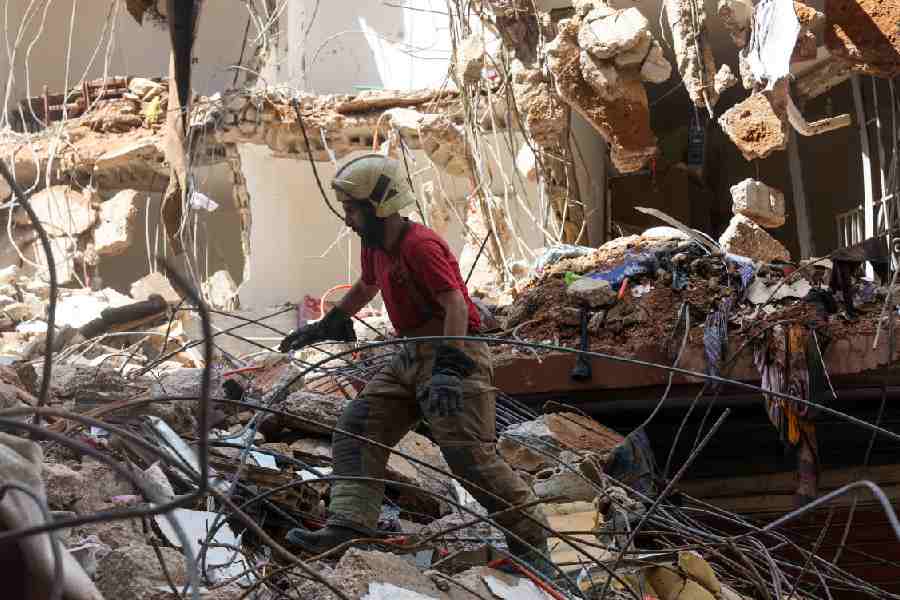 A rescuer works at the site of an Israeli strike in the southern suburbs of Beirut on Friday.