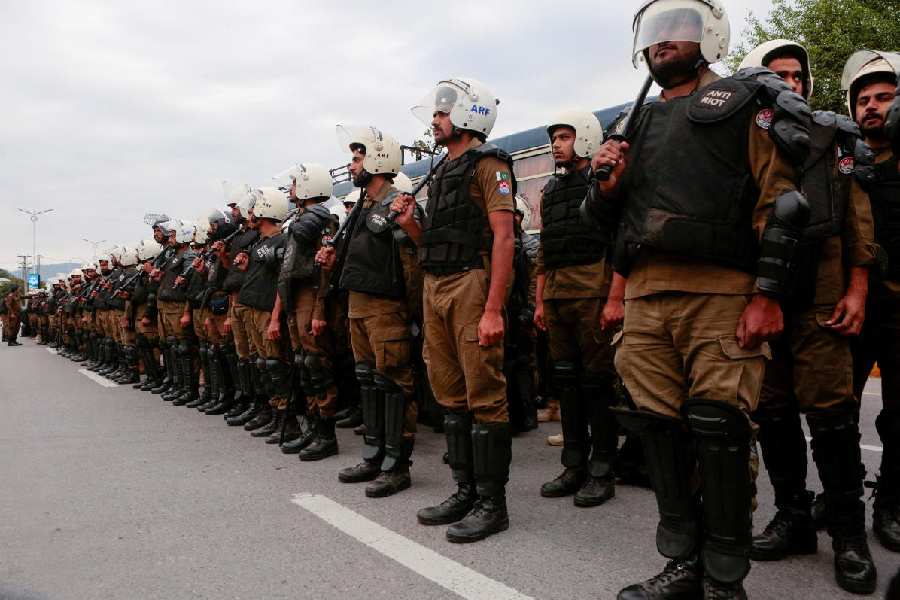 Security personnel stand guard at a road leading to the Serena Hotel as delegations from the United States and Iran are expected to hold peace talks in Islamabad, Pakistan, April 11, 2026.