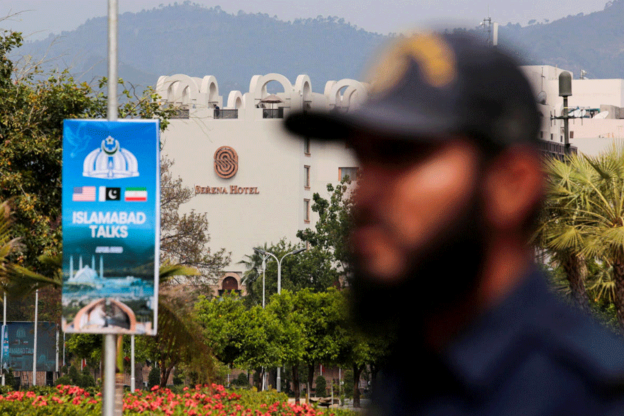 A security personnel stands guard outside the media centre near the road leading to Serena Hotel, as delegations from the United States and Iran are expected to hold peace talks in Islamabad, Pakistan, April 11, 2026.