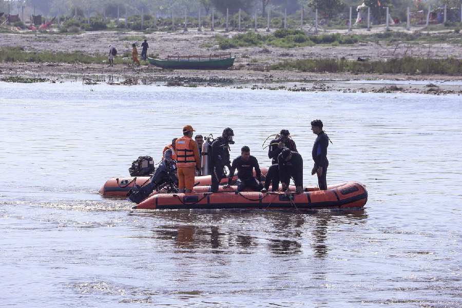 Rescue personnel during a search operation in the Yamuna river after a boat carrying pilgrims capsized on Friday, near Kesi Ghat, in Mathura district, Saturday, April 11, 2026.