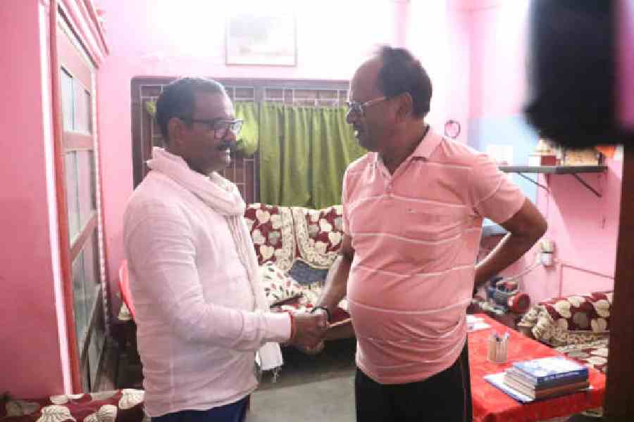 Trinamool candidate from the Cooch Behar South Assembly seat, Abhijit De Bhowmik (left), greets BJP MLA Nikhil Ranjan Dey at the latter’s house in Cooch Behar on Saturday. Picture by Main Uddin Chisti