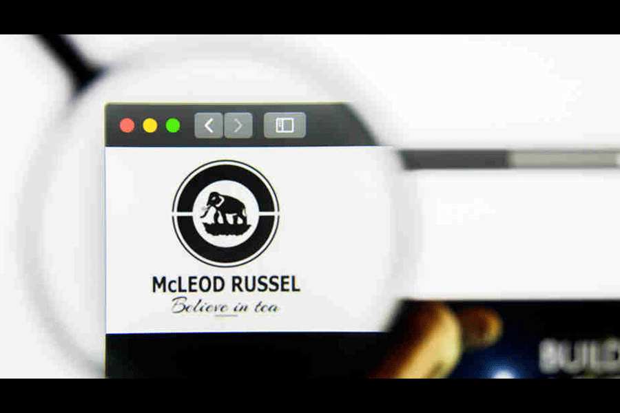 A logo of McLeod Russel under a magnifying glass
