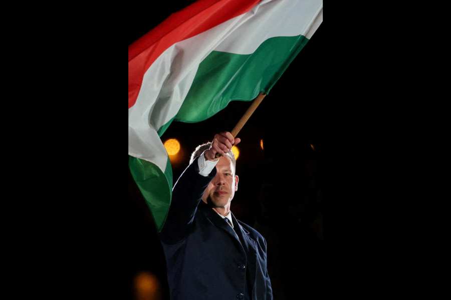 Peter Magyar waves a Hungarian flag
