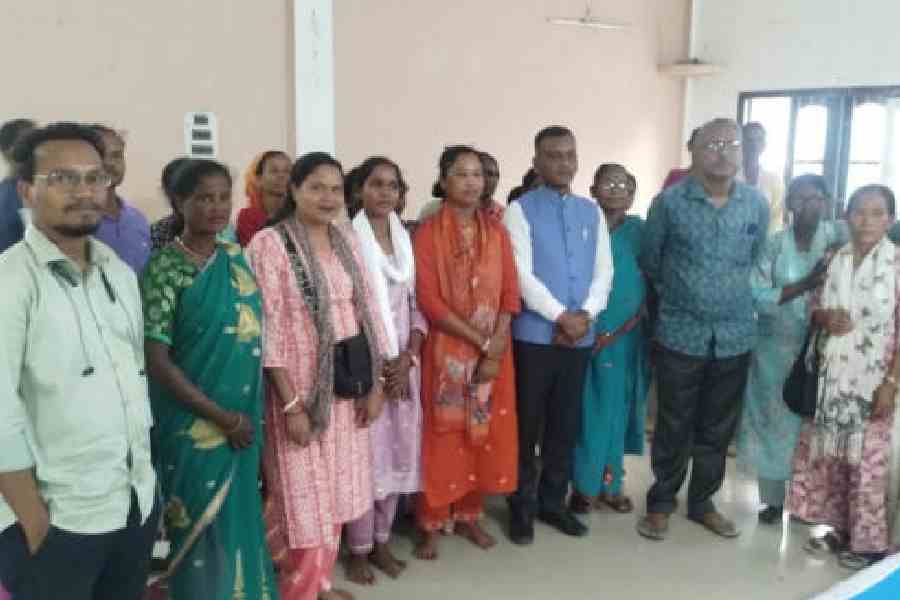 Manoj Tigga, the BJP MP of Alipurduar (in blue vest), with tea workers at the Jubilee Club in Birpara on Sunday. Picture by Anirban Choudhury