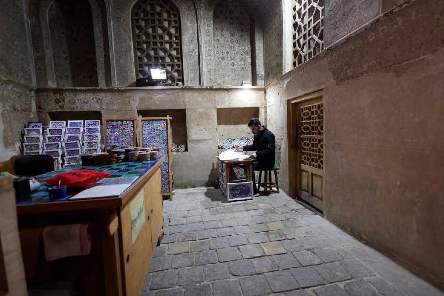 An artisan works inside a workshop near Naqsh-e Jahan Square, a Unesco World Heritage site, in Isfahan, Iran, March 23, 2026. 
