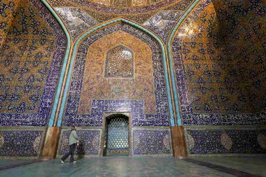 A woman walks inside a mosque at Naqsh-e Jahan Square, a Unesco World Heritage Site, in Isfahan, Iran, March 24, 2026. 