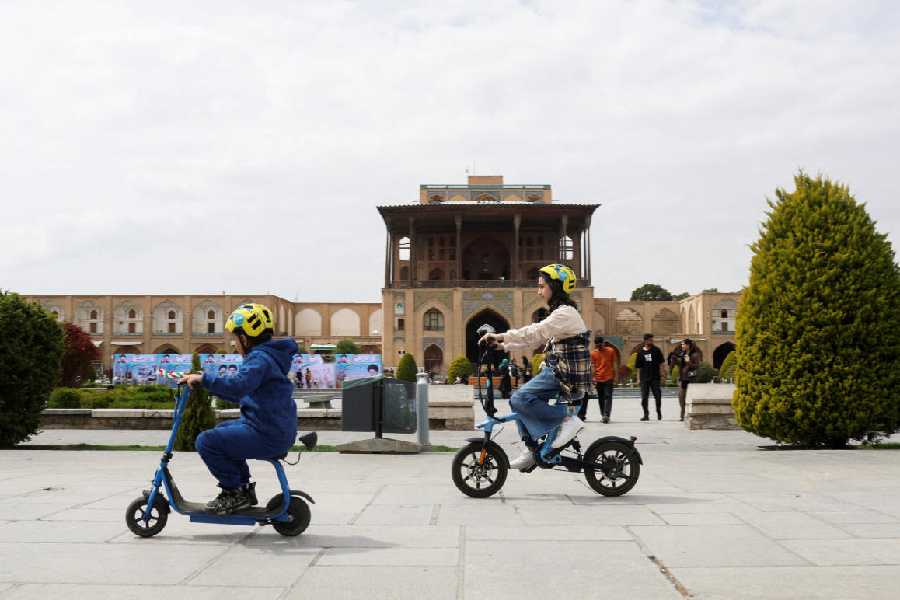 Children ride scooters in Naqsh-e Jahan Square, a UNESCO World Heritage site, in Isfahan, Iran, March 24, 2026.