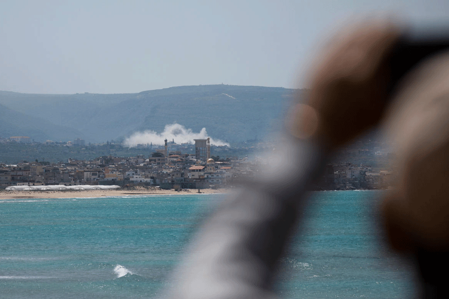 Smoke rises following an Israeli strike at Qlaileh as seen from Tyre