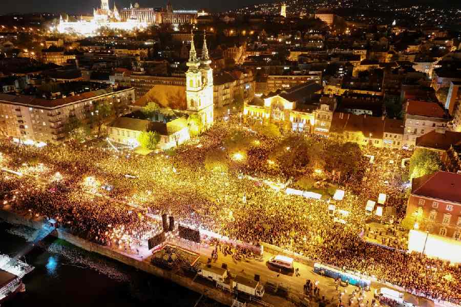 A drone view shows people gathering to celebrate across the River Danube from the Parliament building, following the partial results of the parliamentary election, in Budapest, Hungary, April 12, 2026.
