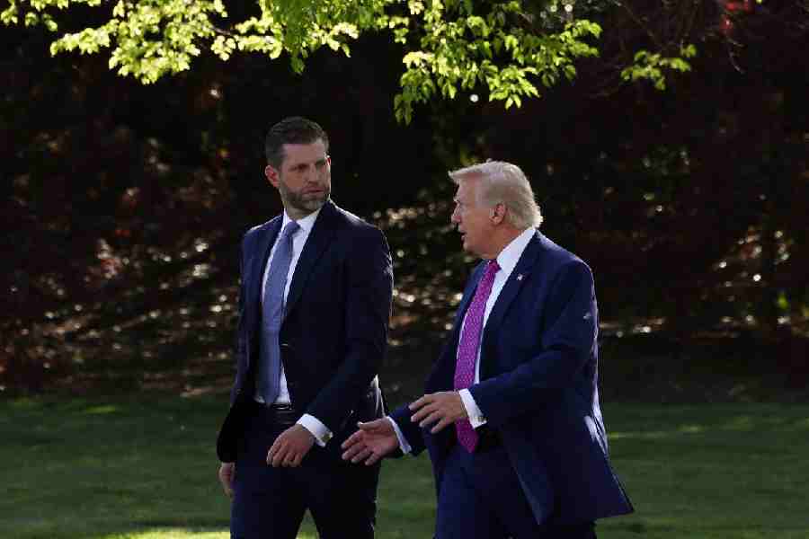 US President Donald Trump speaks with Eric Trump as they walk together to depart the White House in Washington, D.C., US, April 10, 2026.