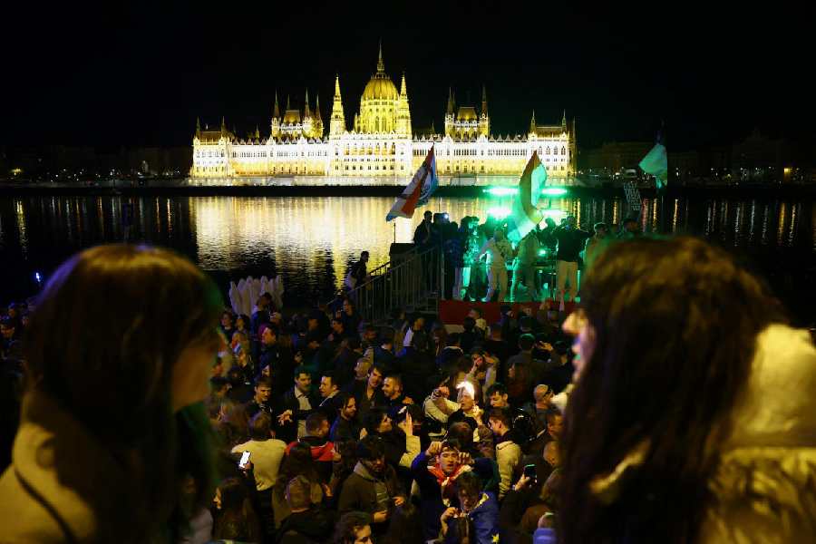 People celebrate following partial results in the Hungarian Parliamentary election in Budapest, Hungary, April 13, 2026. 