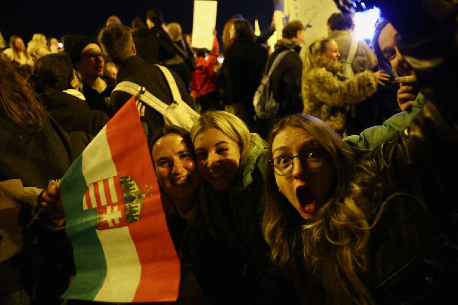 People celebrate following partial results on the day of the Hungarian Parliamentary election in Budapest, Hungary, April 13, 2026. 