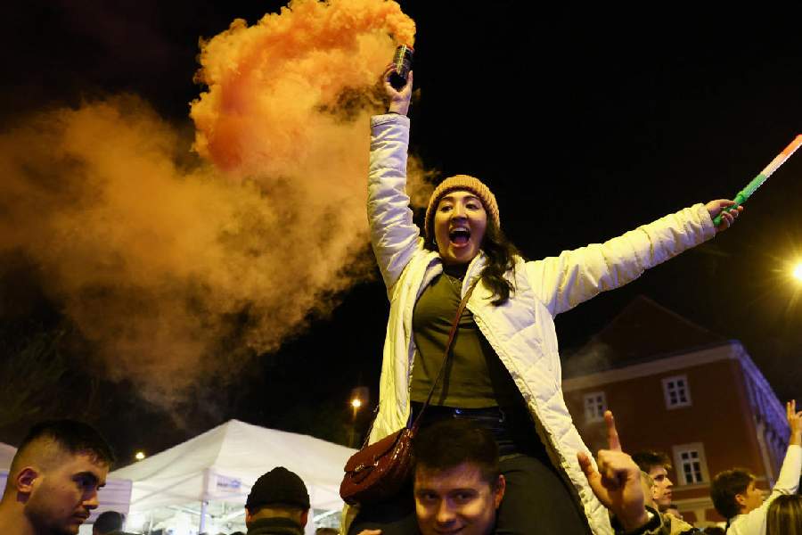 People celebrate following partial results on the day of the Hungarian Parliamentary election in Budapest, Hungary, April 13, 2026.