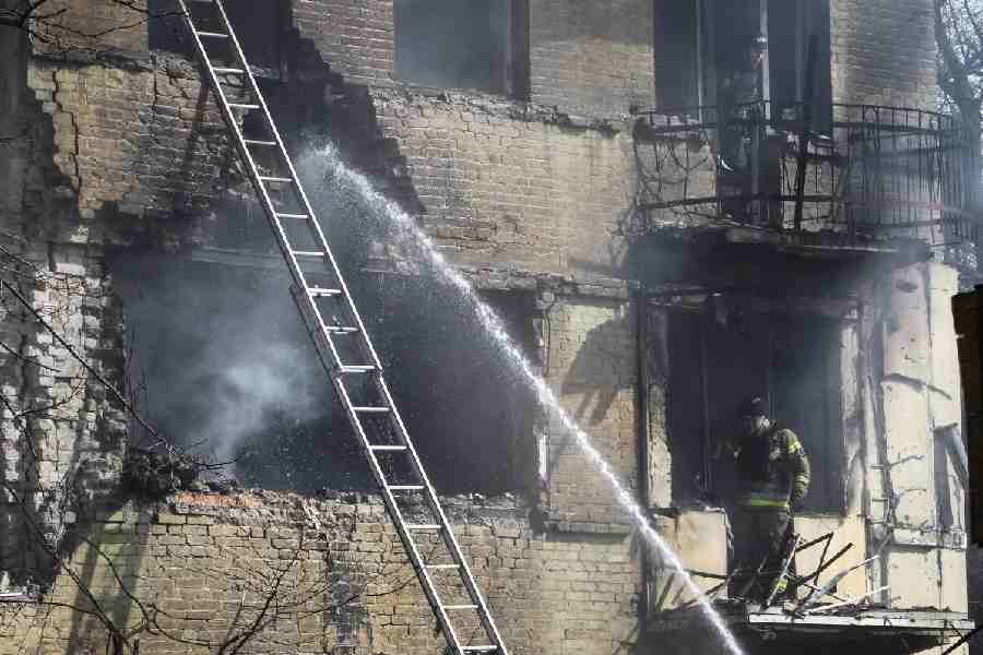 Rescuers work at the site of an apartment building hit by a Russian drone strike, amid Russia's attack on Ukraine, in Dnipro, Ukraine March 26, 2026.