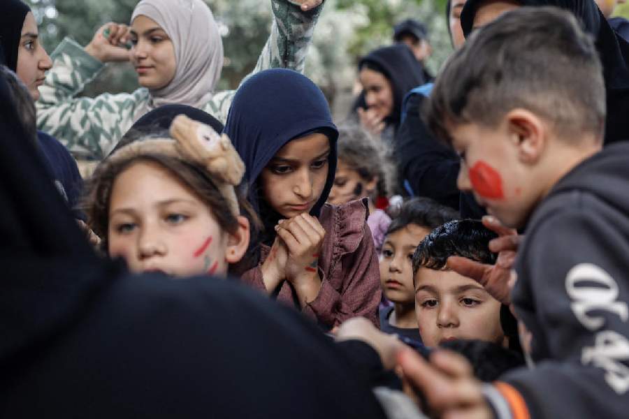 Displaced children queue to get toys, in a shelter in Tyre, south Lebanon, April 14, 2026. 